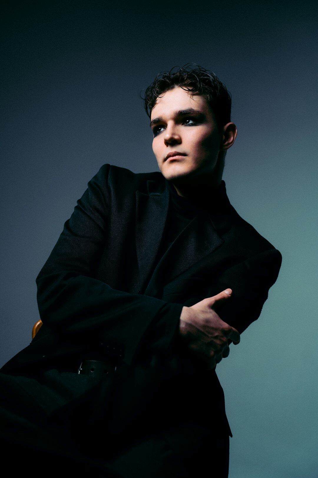 Studio portrait of a Dutch actor in a dark suit with a thoughtful expression