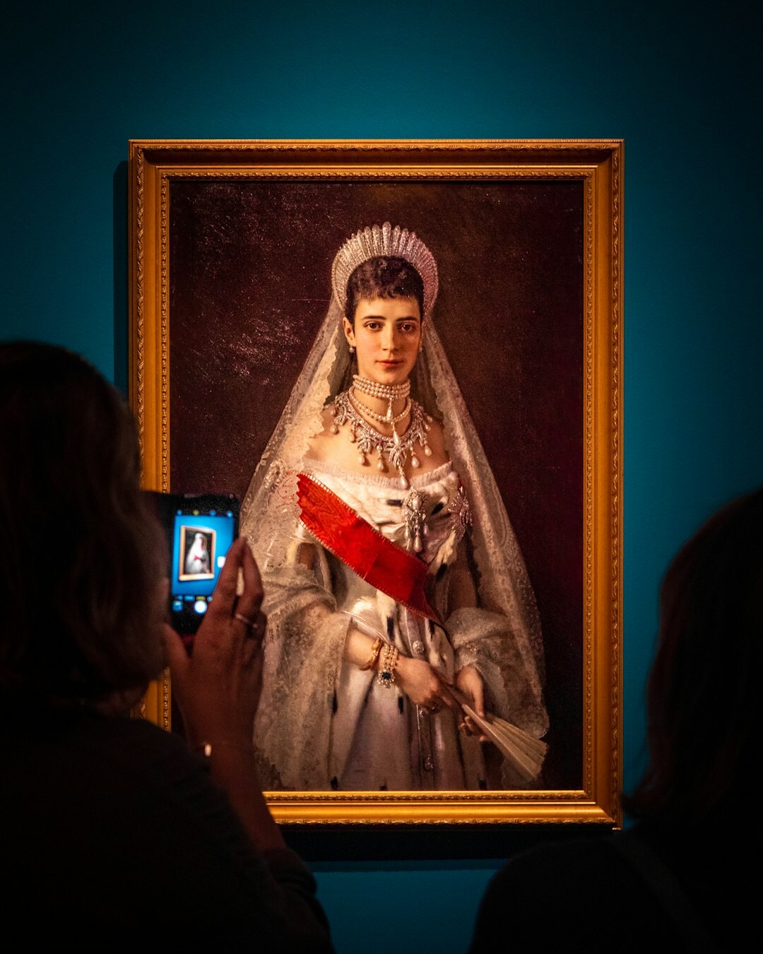 Studio portrait of an elegant Dutch woman in vintage-inspired couture gown